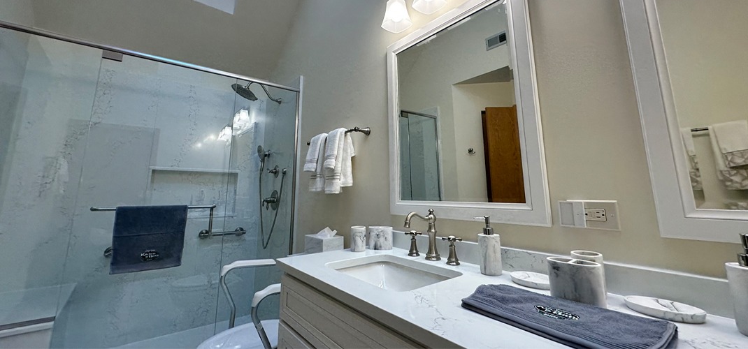 Bathroom remodel featuring Bertch Bath cabinetry, Kohler sink, Moen Weymouth fixtures, Daltile tile, and Vicostone quartz.